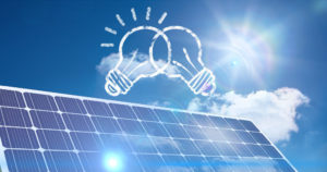 pannello fotovoltaico, cielo azzurro e due lampadine disegnate